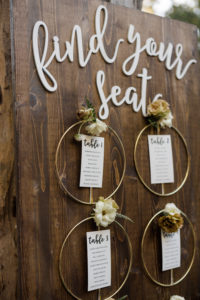 A chic rustic wedding at Calamigos Ranch, circle bouquet seating chart and escort board