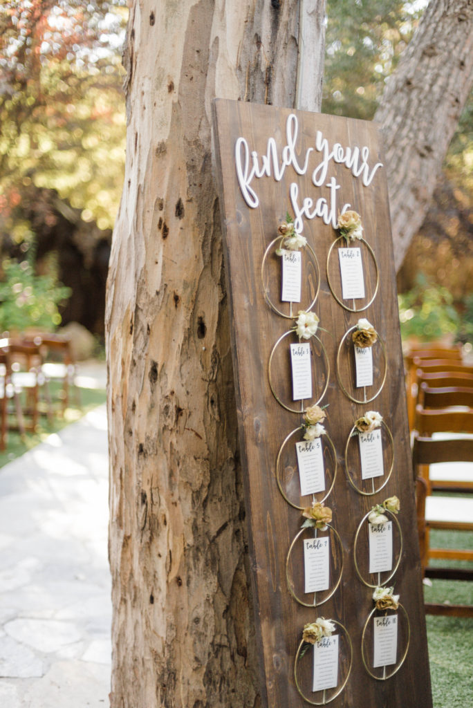 A chic rustic wedding at Calamigos Ranch, circular floral seating chart