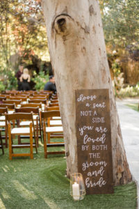 A chic rustic wedding at Calamigos Ranch, wooden find a seat sign for wedding ceremony