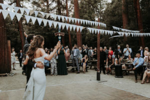 Summer camp themed wedding reception in Big Bear at Camp Wasegan, bride and groom grand entrance