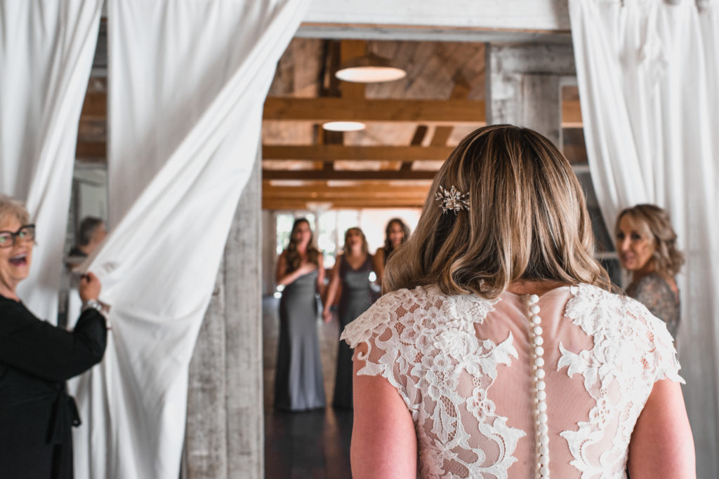 A simple and modern wedding at Triunfo Creek Vineyards, bride reveal to bridesmaids