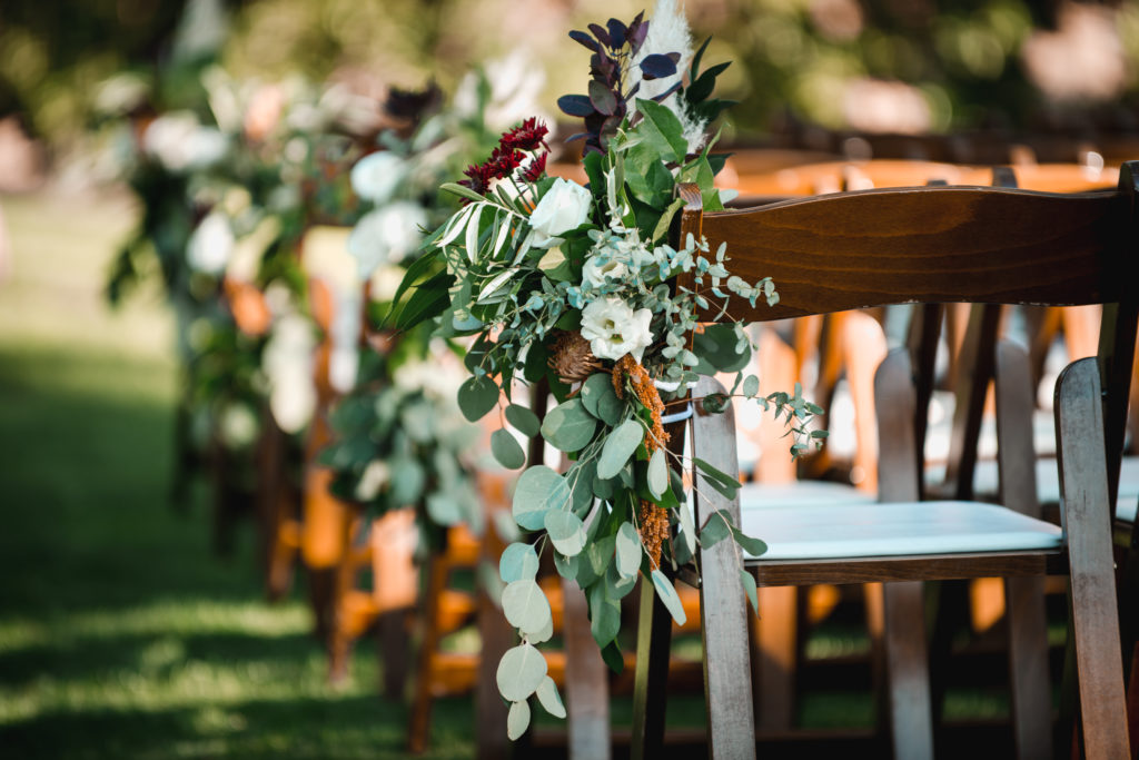 A simple and modern wedding ceremony at Triunfo Creek Vineyards, eucalyptus aisle flowers