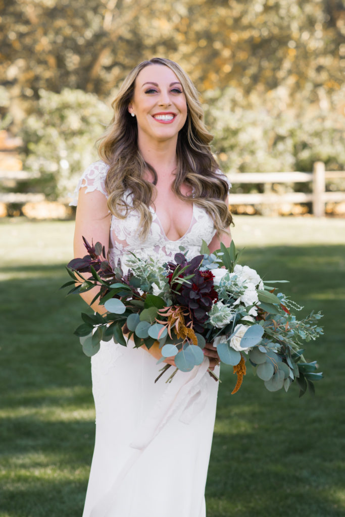 A simple and modern wedding at Triunfo Creek Vineyards, bride with bridal bouquet with greenery and maroon flowers