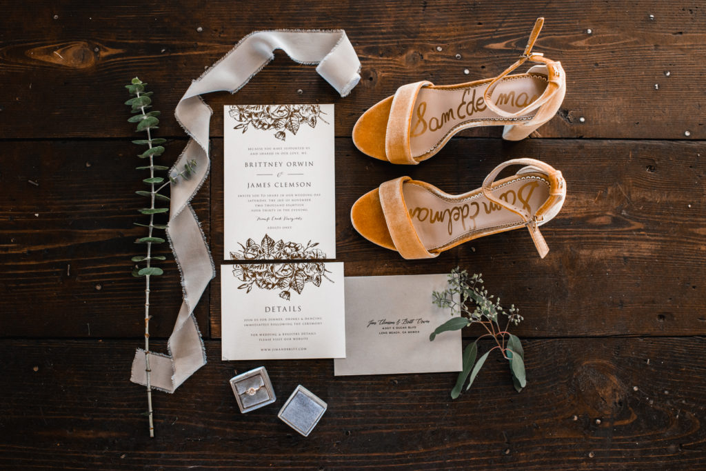 A simple and modern wedding at Triunfo Creek Vineyards, gold foiled invitation with velvet yellow bridal shoes