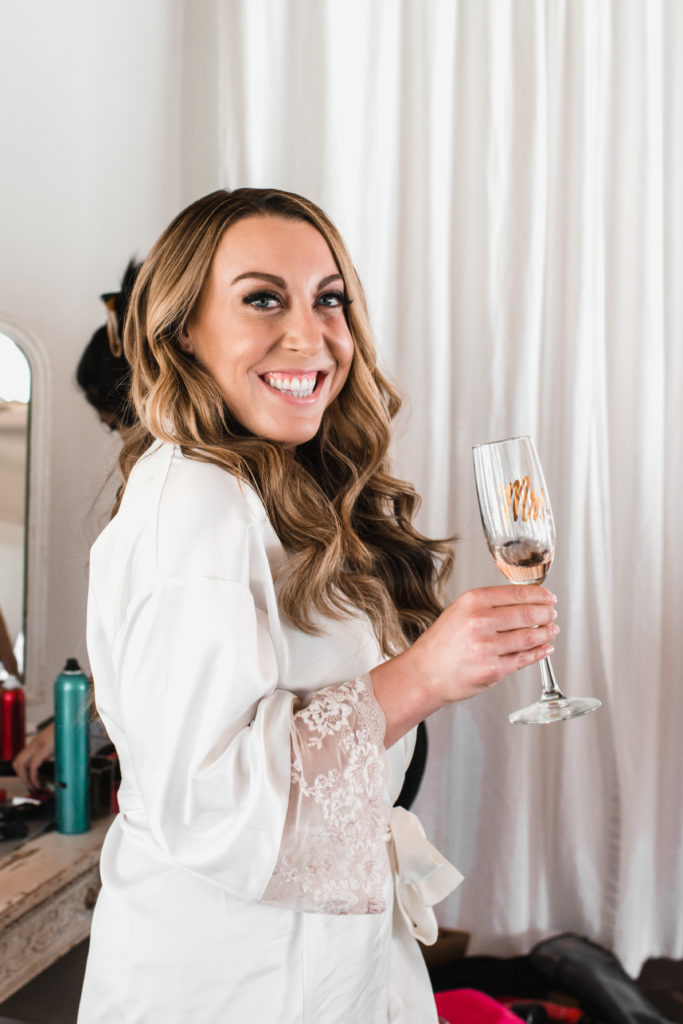 A simple and modern wedding at Triunfo Creek Vineyards, bride getting ready with specialty flute
