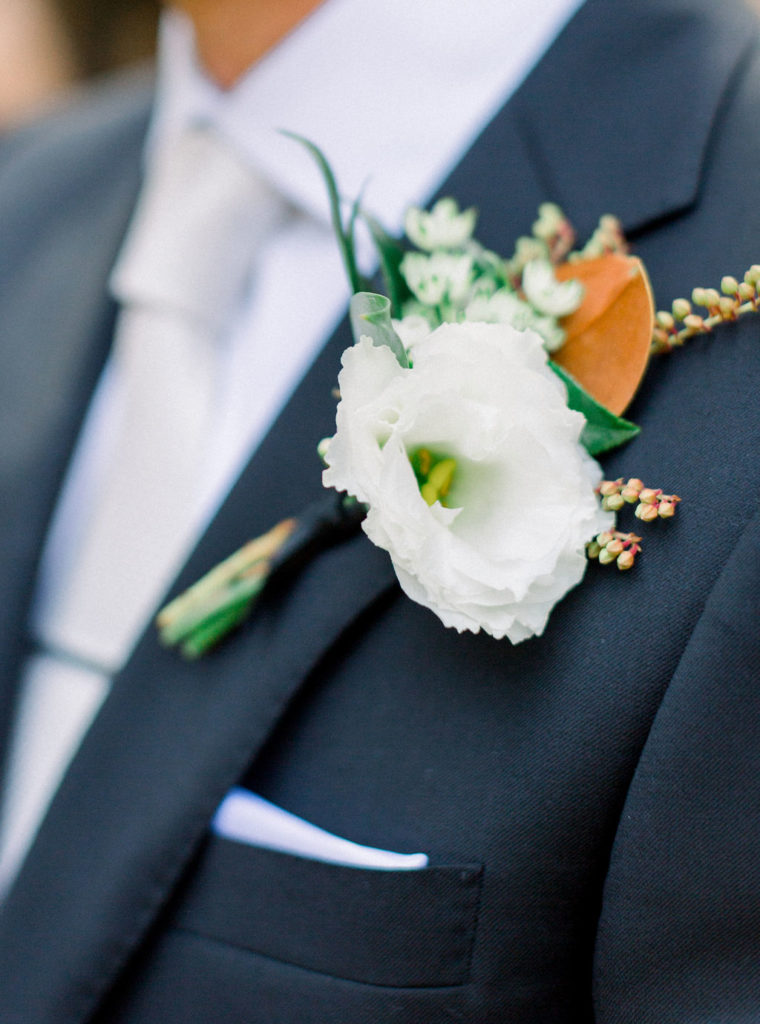 A Romantic Fall Wedding at Maravilla Gardens, groom with magnolia leaf boutonniere and white flower