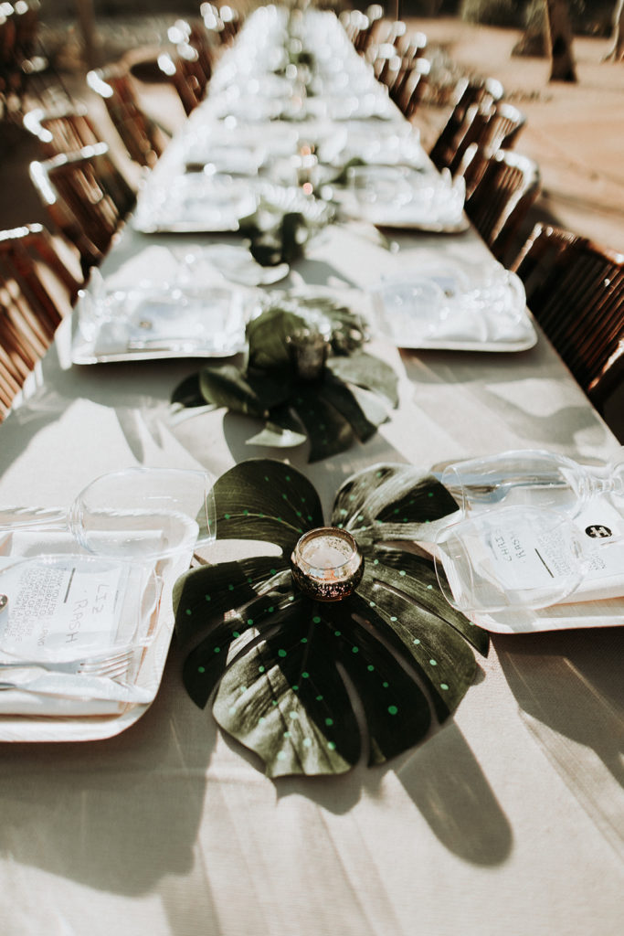 A Joshua Tree wedding at Tumbleweed Sanctuary, reception tables with monstera leaf centerpieces
