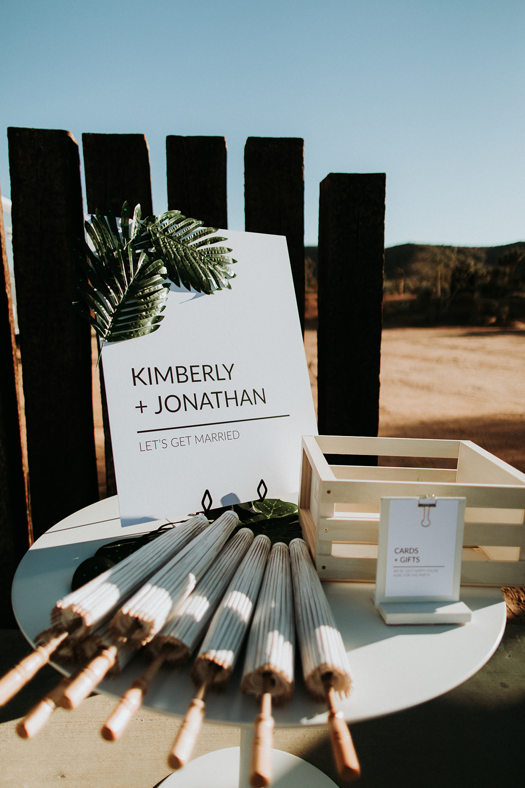 A Joshua Tree wedding at Tumbleweed Sanctuary, modern welcome table umbrellas