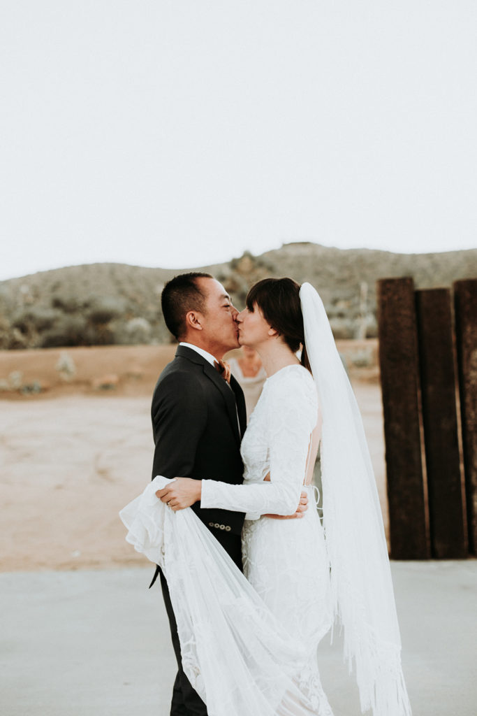 A Joshua Tree wedding at Tumbleweed Sanctuary, modern bride and groom kiss 