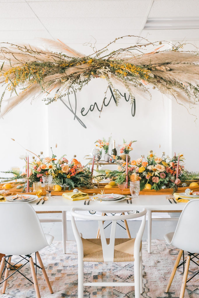 Spring Fever inspired styled shoot at La Piñata + Feathered Arrow Events using orange, pink and yellow in your wedding, hanging floral installation