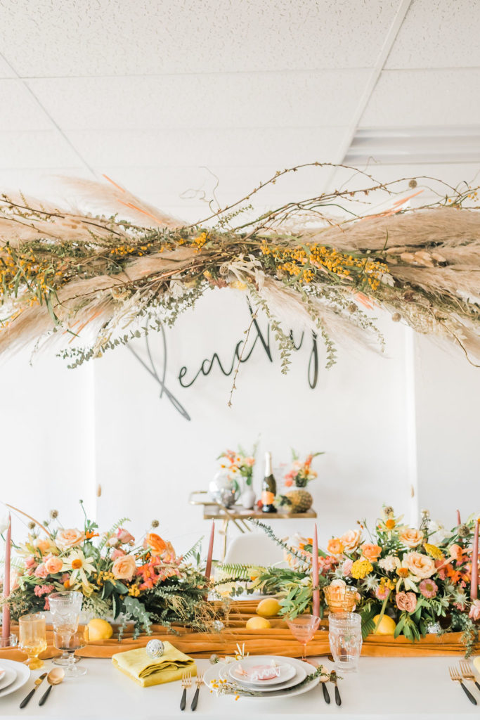 Spring Fever inspired styled shoot at La Piñata + Feathered Arrow Events using orange, pink and yellow in your wedding, wildflower hanging installation and centerpieces