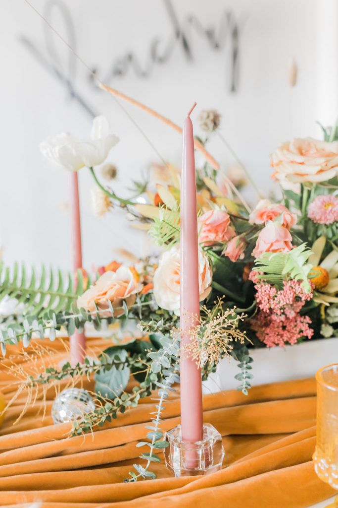 Spring Fever inspired styled shoot at La Piñata + Feathered Arrow Events using orange, pink and yellow in your wedding, wildflower centerpiece and pink taper candles