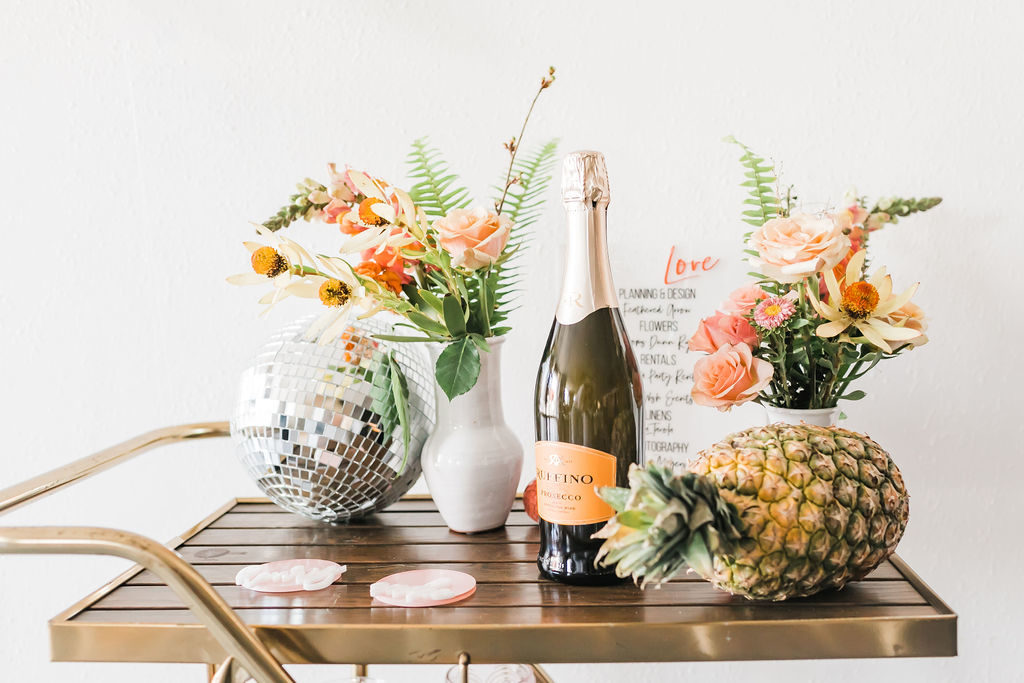 Spring Fever inspired styled shoot at La Piñata + Feathered Arrow Events using orange, pink and yellow in your wedding, wildflower hanging installation over bar