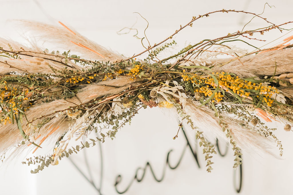 Spring Fever inspired styled shoot at La Piñata + Feathered Arrow Events using orange, pink and yellow in your wedding, wildflower hanging installation with peachy sign