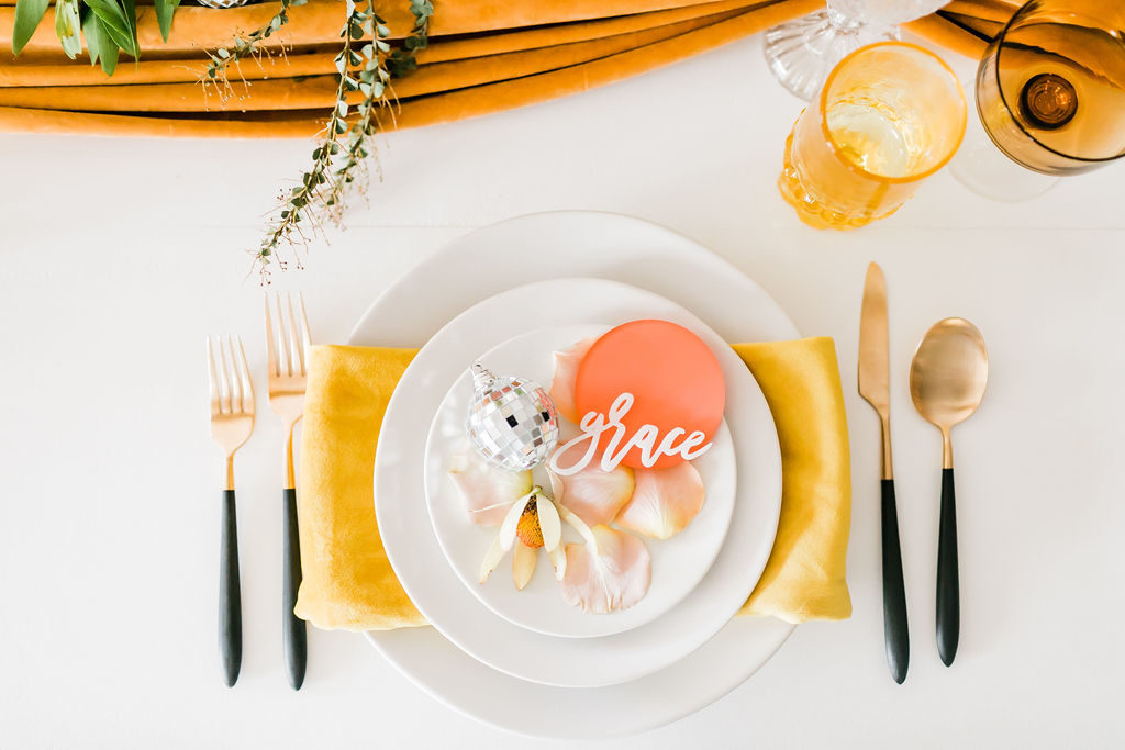 Spring Fever inspired styled shoot at La Piñata + Feathered Arrow Events using orange, pink and yellow in your wedding, hanging floral installation, tables cape with disco balls