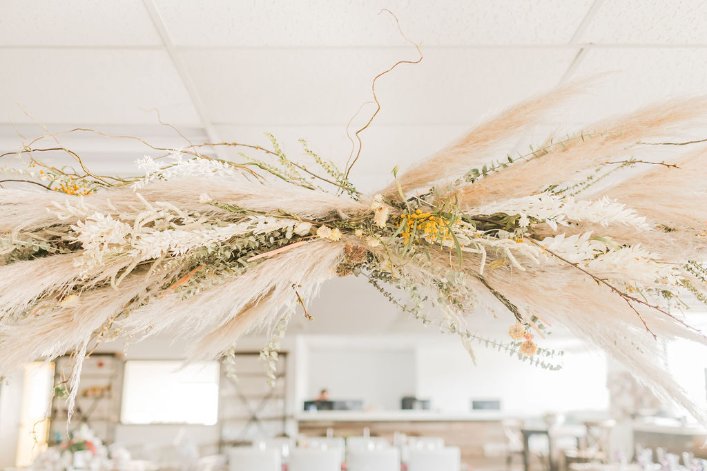 Spring Fever inspired styled shoot at La Piñata + Feathered Arrow Events using orange, pink and yellow in your wedding, wildflower hanging installation