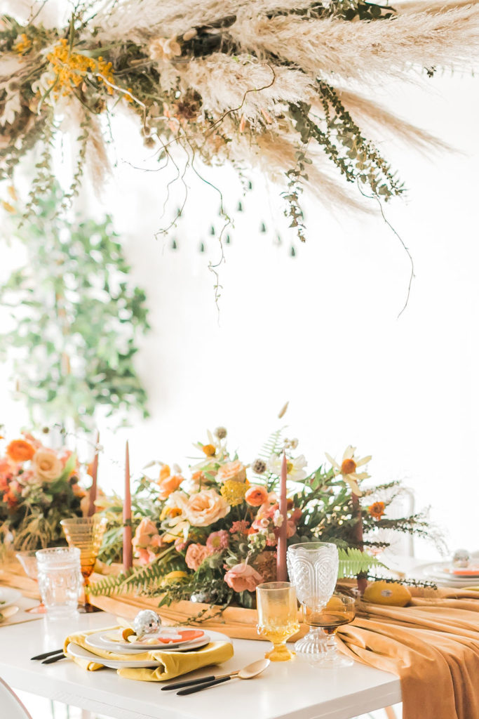 Spring Fever inspired styled shoot at La Piñata + Feathered Arrow Events using orange, pink and yellow in your wedding, wildflower hanging installation and centerpieces