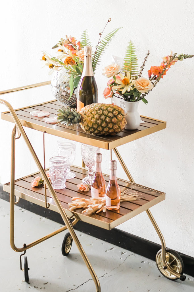 Spring Fever inspired styled shoot at La Piñata + Feathered Arrow Events using orange, pink and yellow in your wedding, wildflower hanging installation over bar