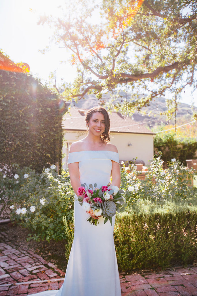 Fall Wedding at Triunfo Creek Vineyards, bride with off shoulder wedding dress and bouquet with a succulent