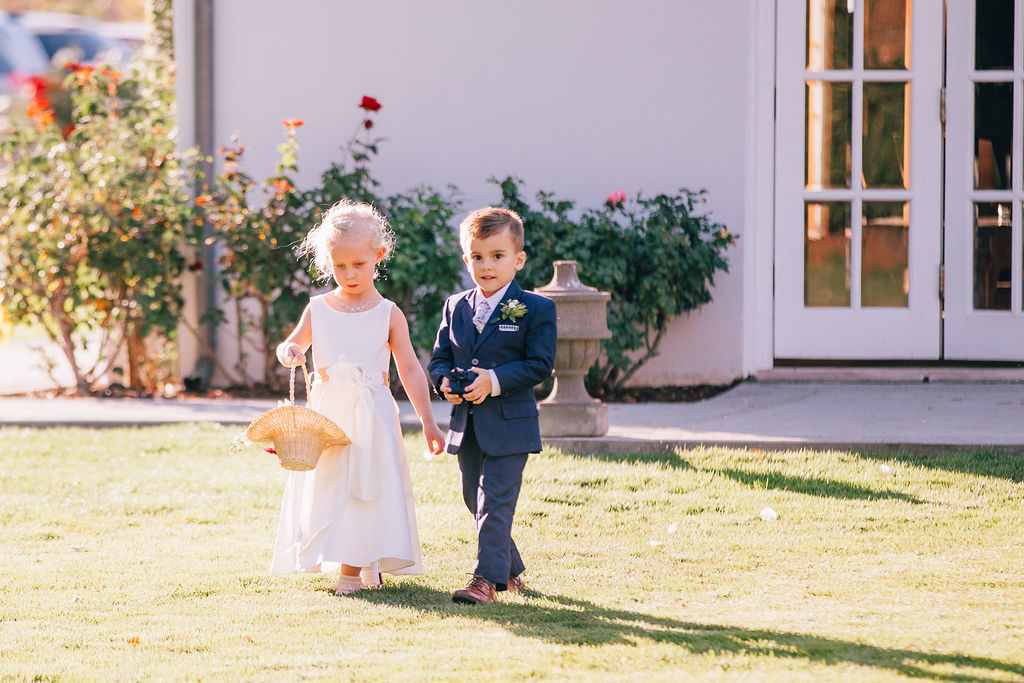 Fall Wedding ceremony at Triunfo Creek Vineyards, flower girl and ring bearer walking down aisle