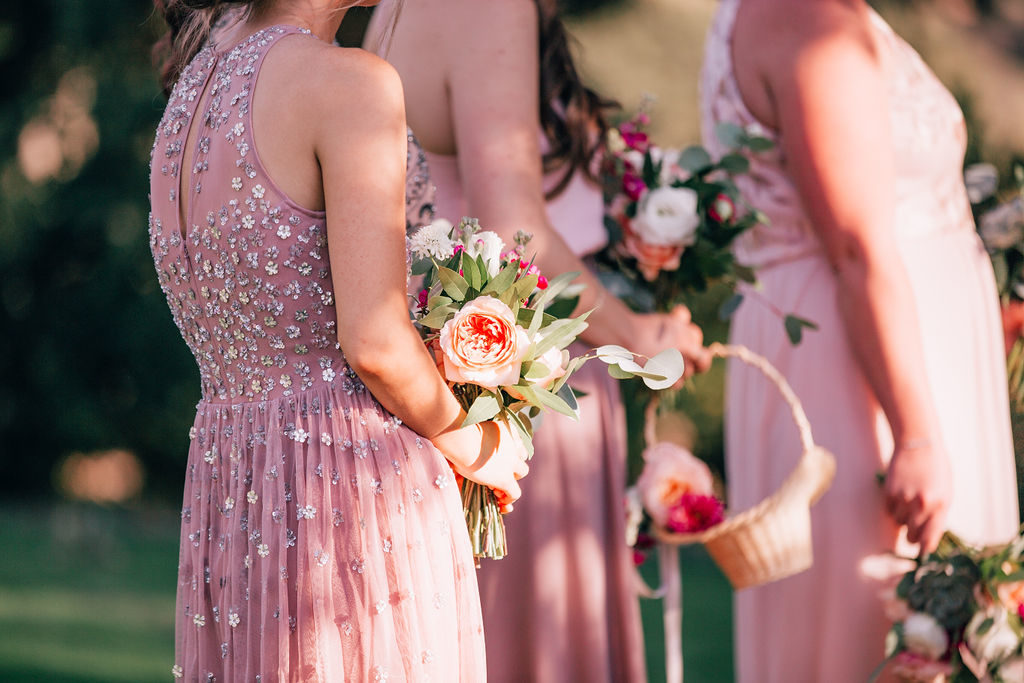 Fall Wedding ceremony at Triunfo Creek Vineyards, bridesmaids in mismatching pink dresses