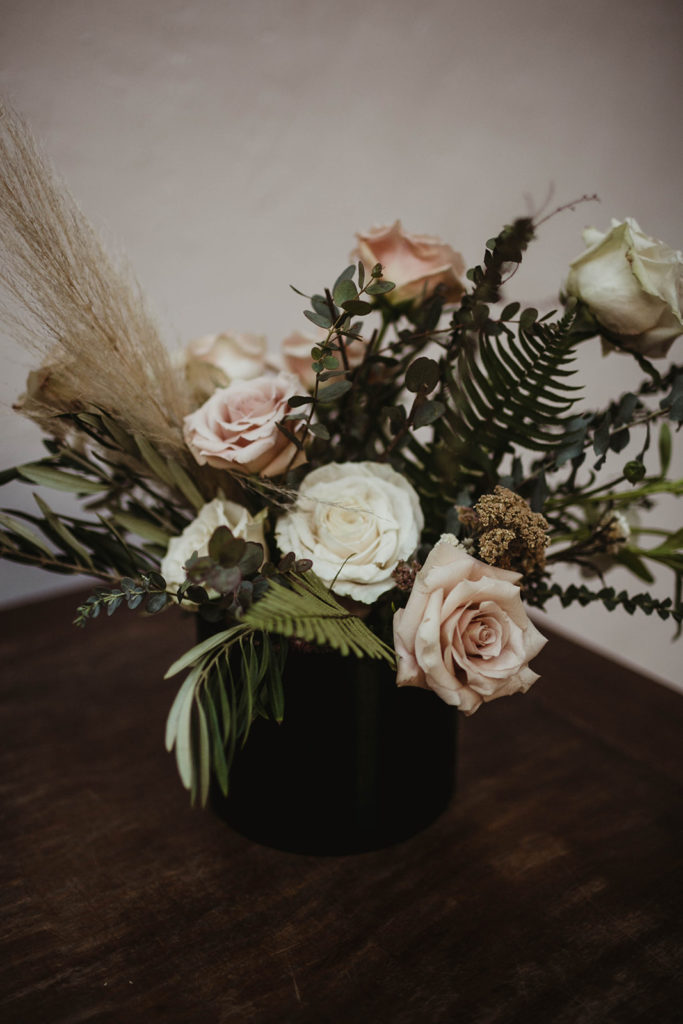 A romantic wedding ceremony at Ebell Long Beach, flower arrangement with blush flowers and pampas grass