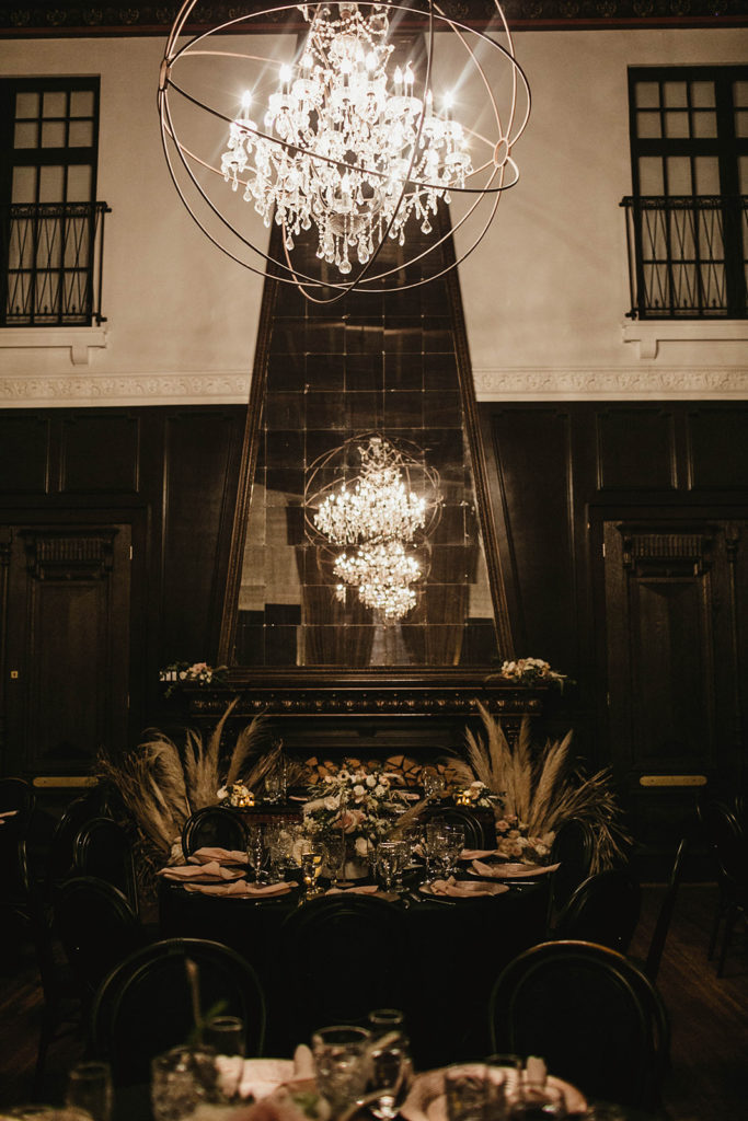 A romantic wedding reception at Ebell Long Beach, sweetheart table with pampas grass arrangement