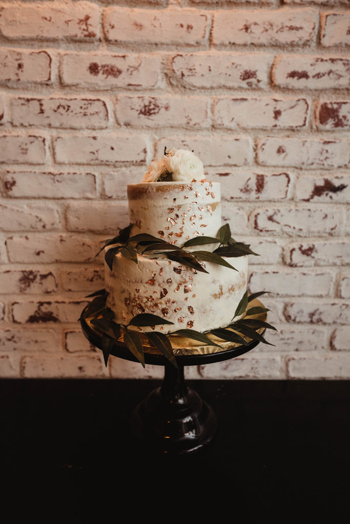 A romantic wedding reception at Ebell Long Beach, small naked cake with greenery