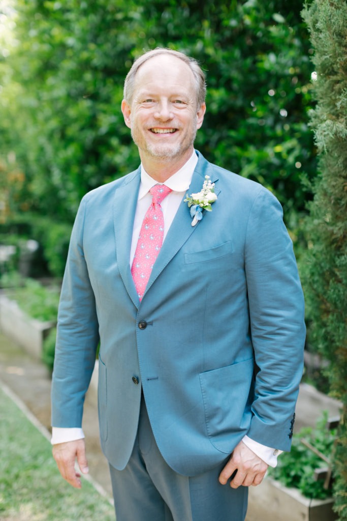 An Al Fresco Wedding at the Valley Hunt club, groom suit with red tie 