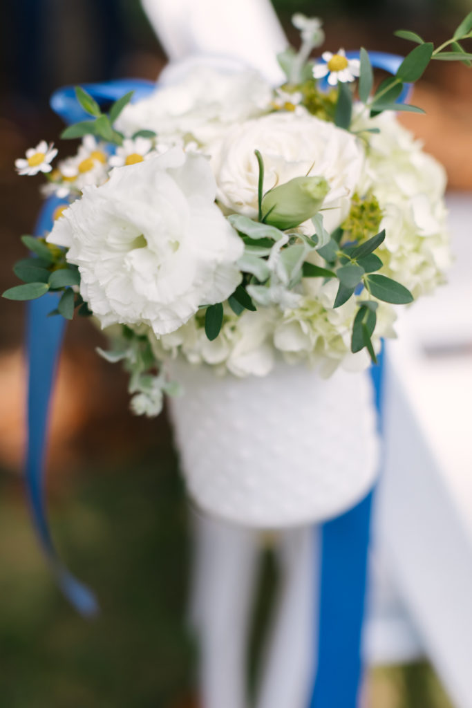 An Al Fresco Wedding ceremony at the Valley Hunt club, white flowers in vases for ceremony aisle flowers