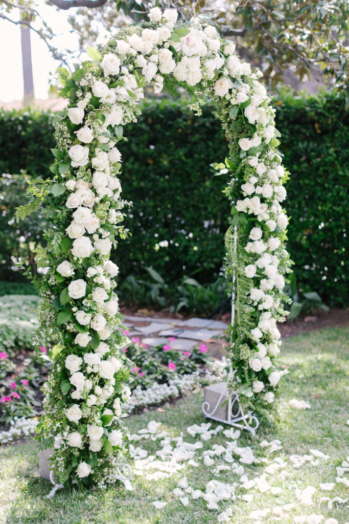 An Al Fresco Wedding ceremony at the Valley Hunt club, white rose ceremony arch