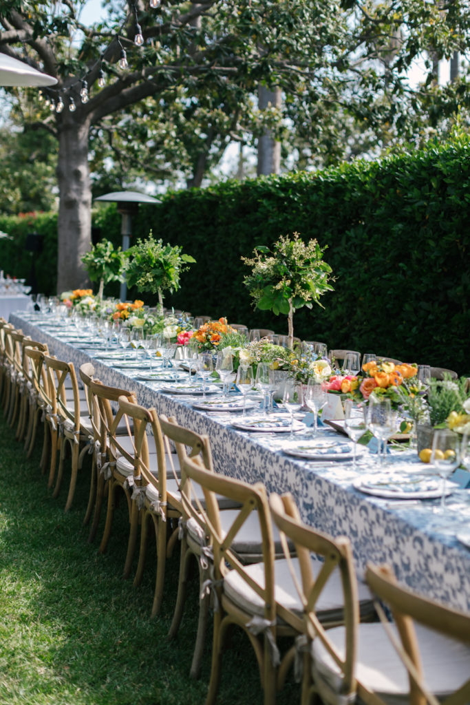 An Al Fresco Wedding reception at the Valley Hunt club, Italian inspired wedding reception, family style table with blue floral patterned tablecloth and fresh citrus 