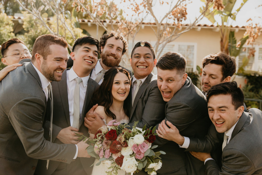 A music festival themed wedding at The Inn at Rancho Santa Fe, wedding party portrait shots, groomsmen in dark grey suits