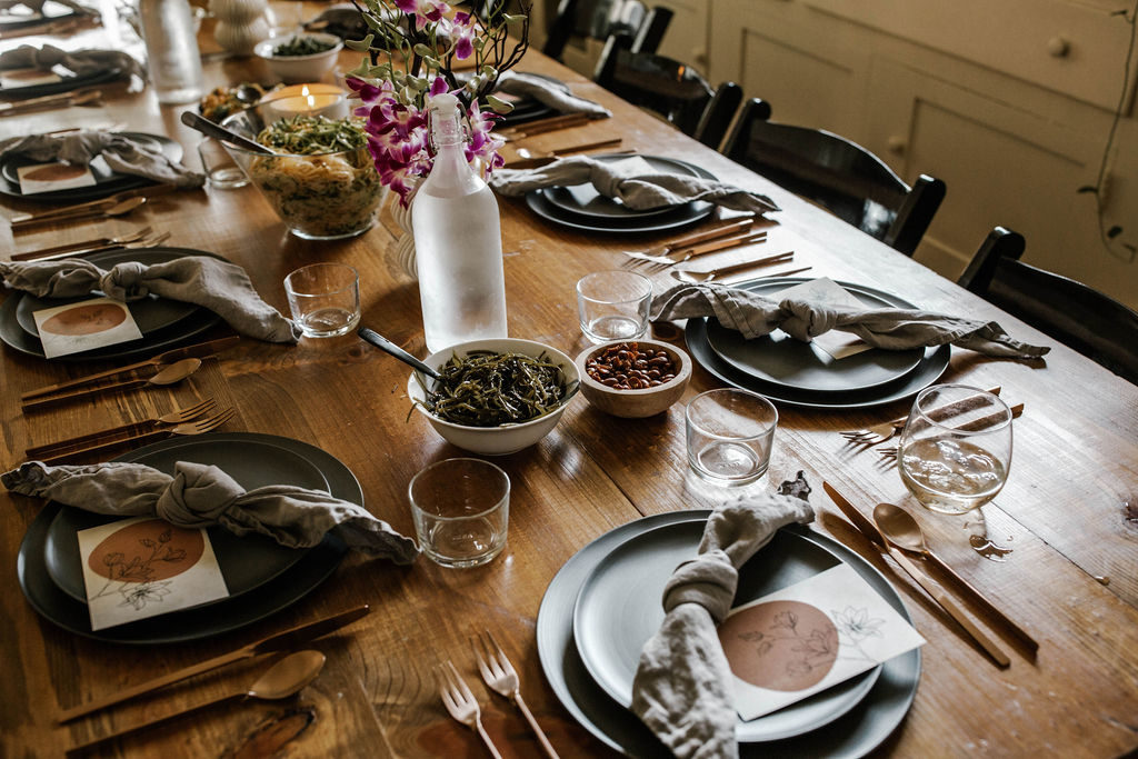 Create Dinners tablescape with black matte plates and orchid centerpieces
