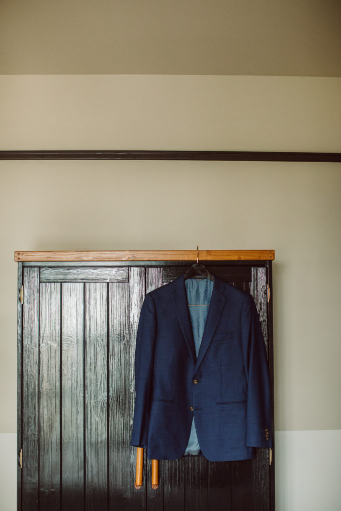 A unique and colorful wedding at the Grass Room in downtown Los Angeles, dark blue groom suit