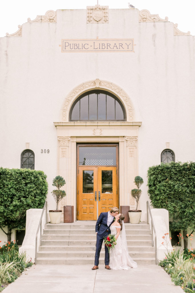 An ocean view wedding ceremony at The Redondo Beach Historic Library, bride and groom first look on the steps of the library