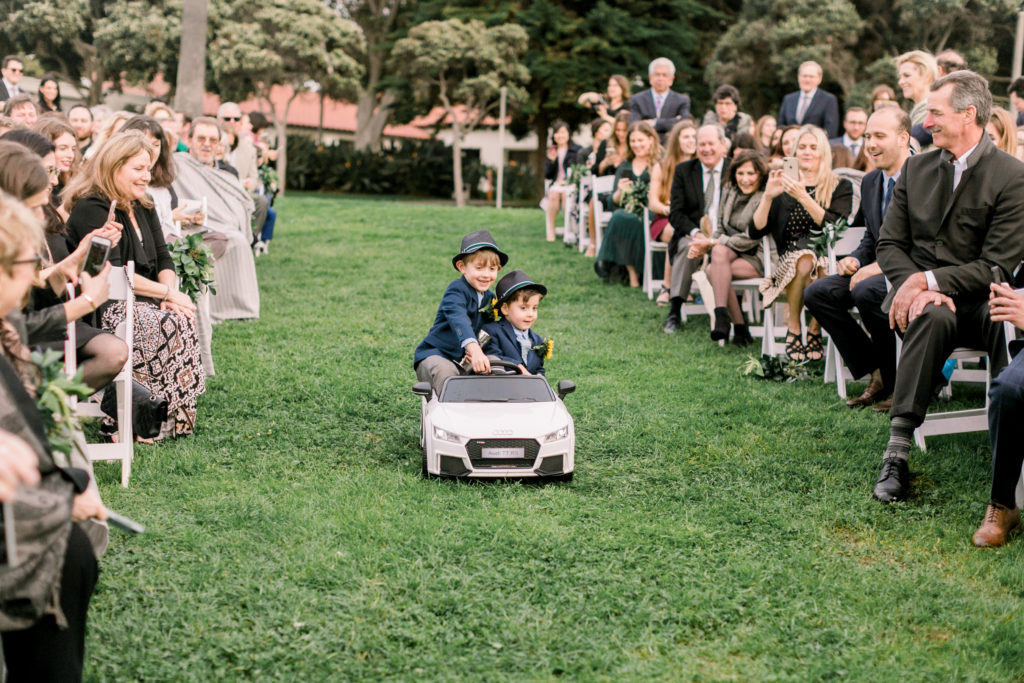 An ocean view wedding ceremony at The Redondo Beach Historic Library, ring bearers driving car down aisle