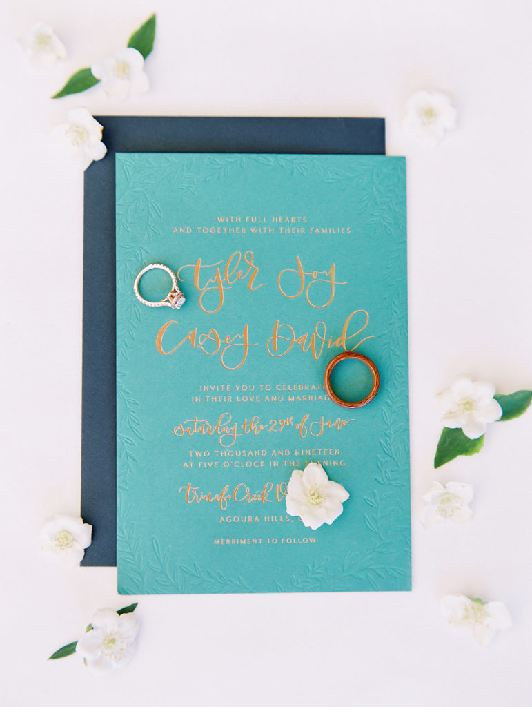 A colorful and vibrant wedding at Triunfo Creek Vineyards, bright teal wedding program