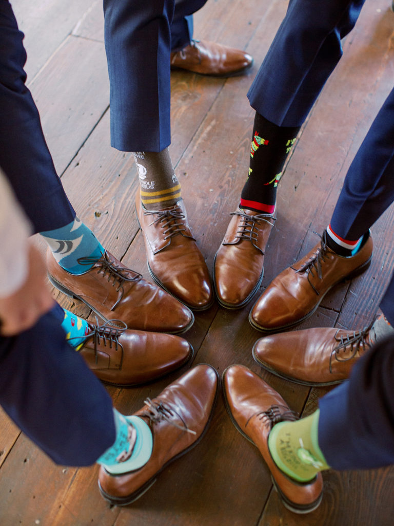 A colorful and vibrant wedding at Triunfo Creek Vineyards, groomsmen funny socks