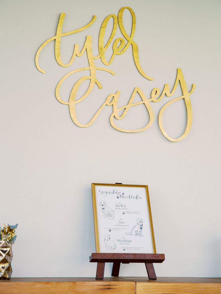 A colorful and vibrant wedding reception at Triunfo Creek Vineyards, bar sign