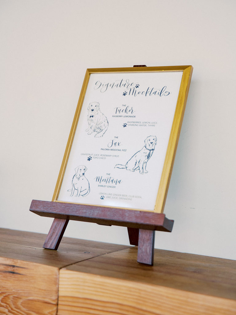 A colorful and vibrant wedding reception at Triunfo Creek Vineyards, dog inspired bar sign