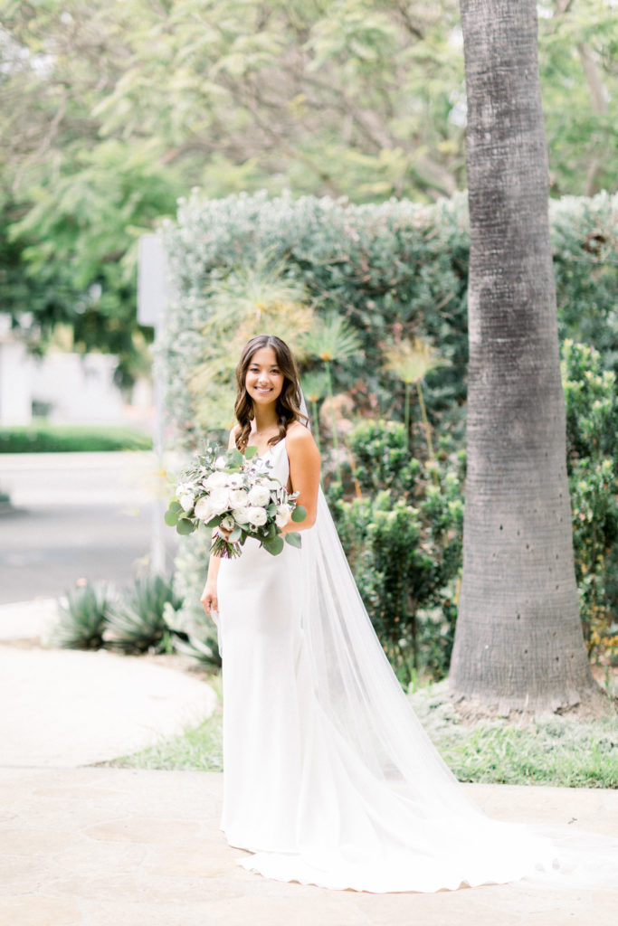 A classic greenhouse wedding at Dos Pueblos Orchid Farm, modern and minimalist bride, bridal portrait shot, green and white bridal bouquet