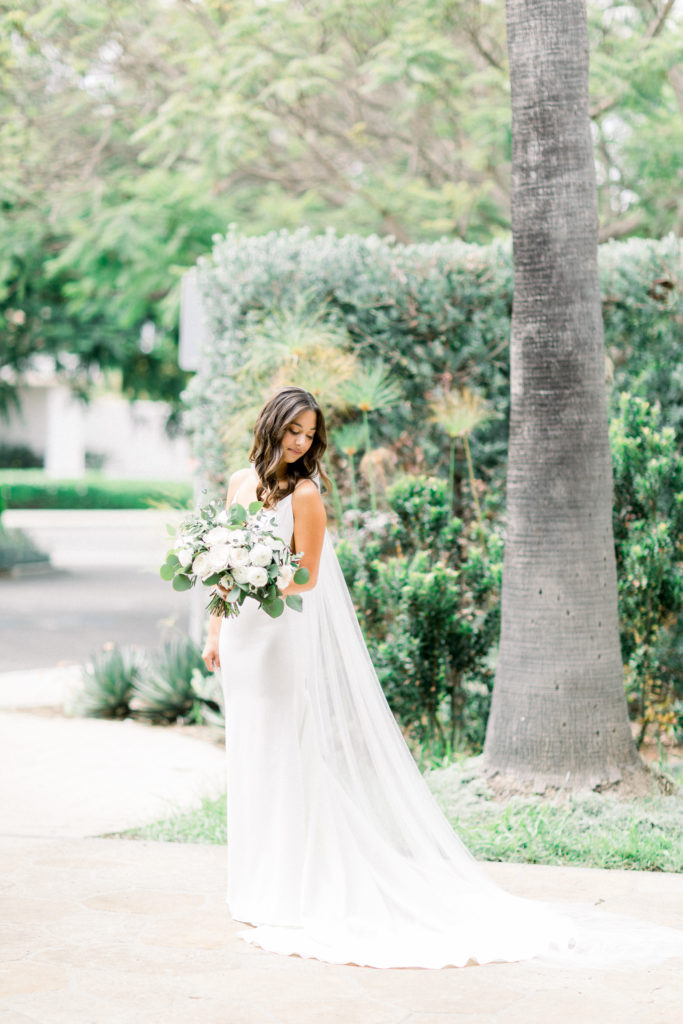 A classic greenhouse wedding at Dos Pueblos Orchid Farm, modern and minimalist bride, bridal portrait shot, green and white bridal bouquet
