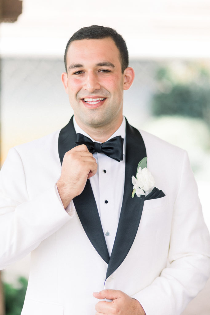 A classic greenhouse wedding at Dos Pueblos Orchid Farm, groom in white and black tux