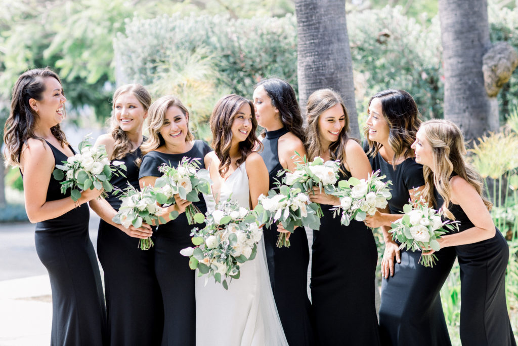 A classic greenhouse wedding at Dos Pueblos Orchid Farm, modern and minimalist bride, bridal portrait shot, green and white bridal bouquet, bridesmaids in black dresses
