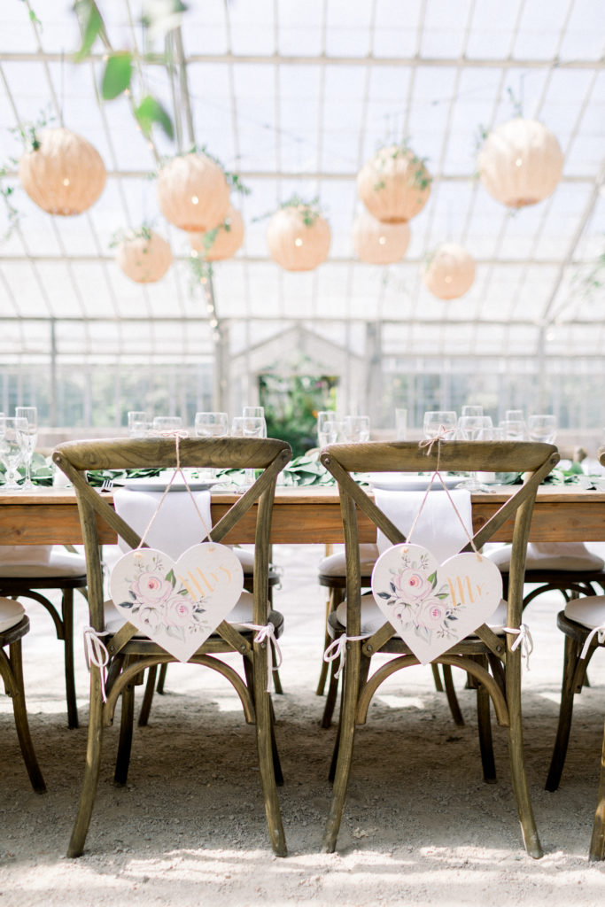 A classic greenhouse wedding reception at Dos Pueblos Orchid Farm, bride and groom chairs
