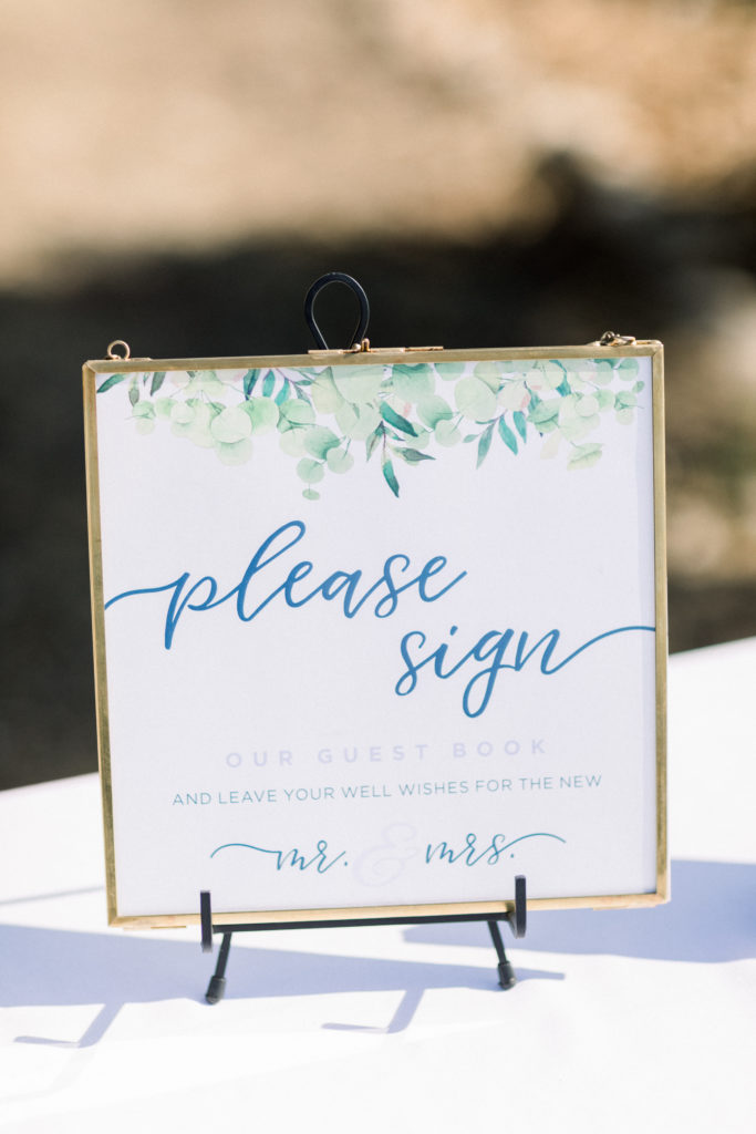 A classic greenhouse wedding ceremony at Dos Pueblos Orchid Farm, watercolor welcome sign