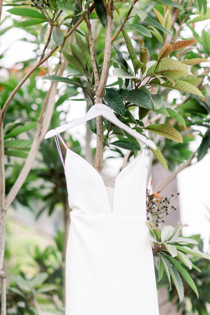 A classic greenhouse wedding at Dos Pueblos Orchid Farm, illusion neckline modern and minimalist wedding dress