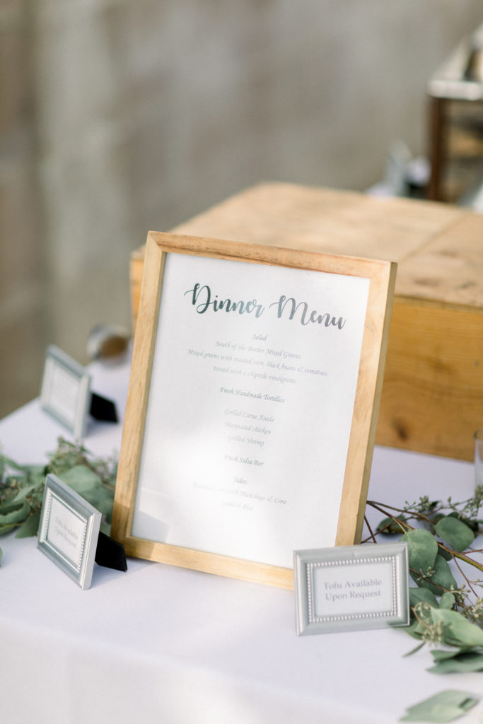 A classic greenhouse wedding reception at Dos Pueblos Orchid Farm, wooden dinner menu sign