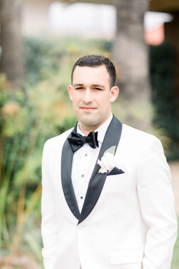 A classic greenhouse wedding at Dos Pueblos Orchid Farm, groom in white and black tuxedo